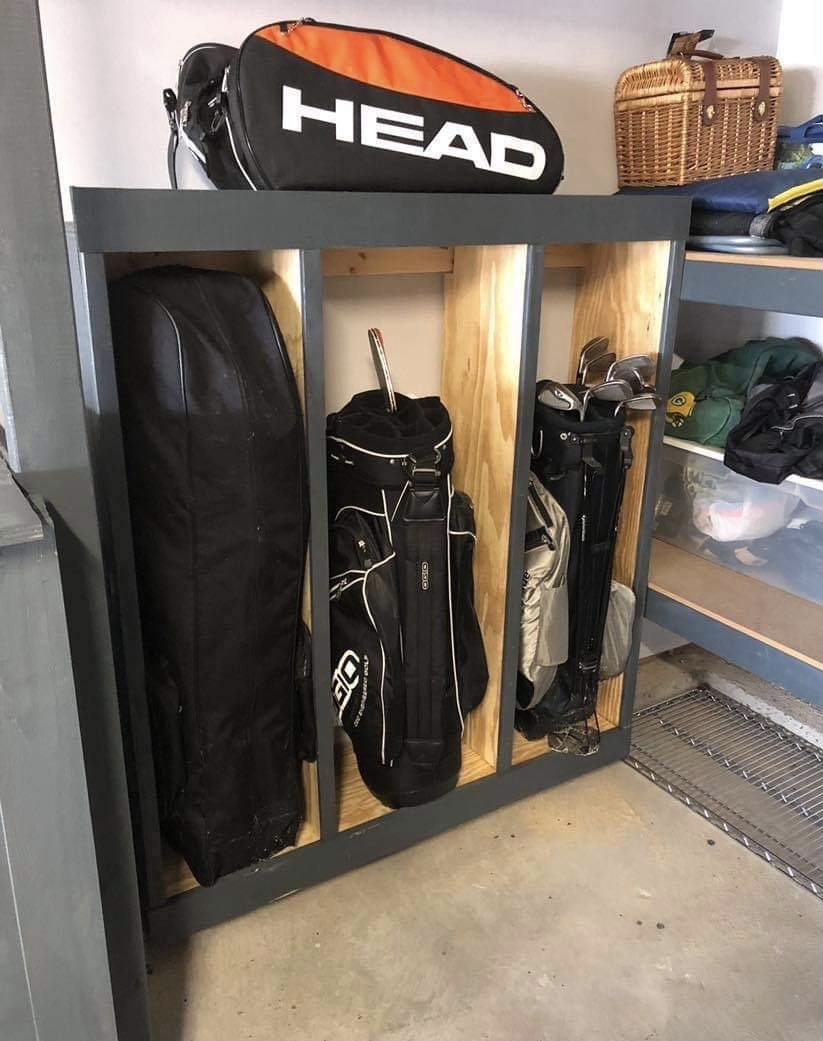 A garage with a custom-built wooden golf bag storage unit and various sports equipment