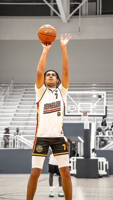 16U DJ shooting a basketball in a sports arena