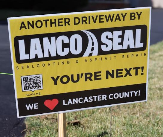 Signboard for Lancco Seal advertising driveway sealing and asphalt repair services