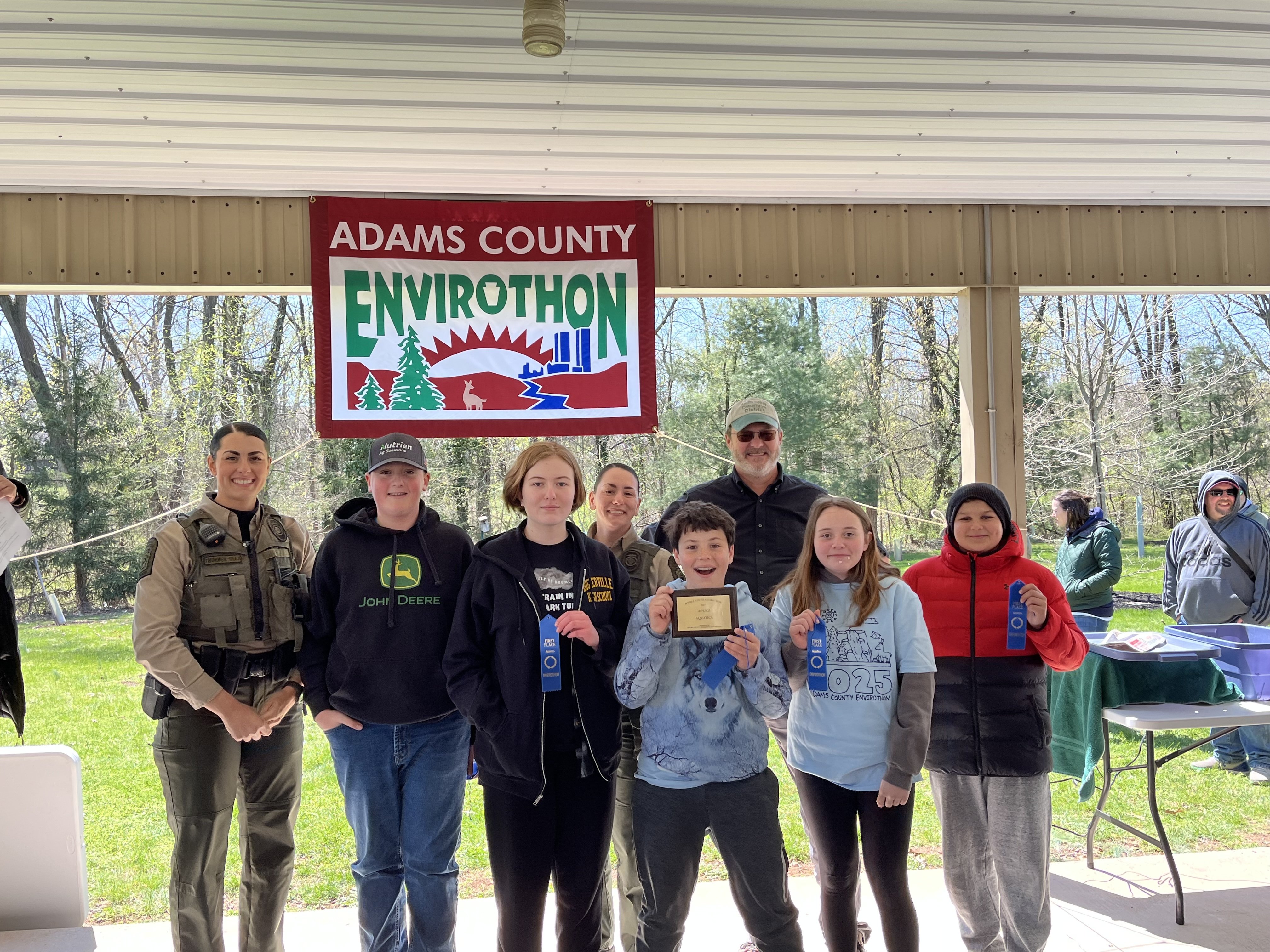 Group of students and adults posing for a photo at the Adams County Envirothon event.