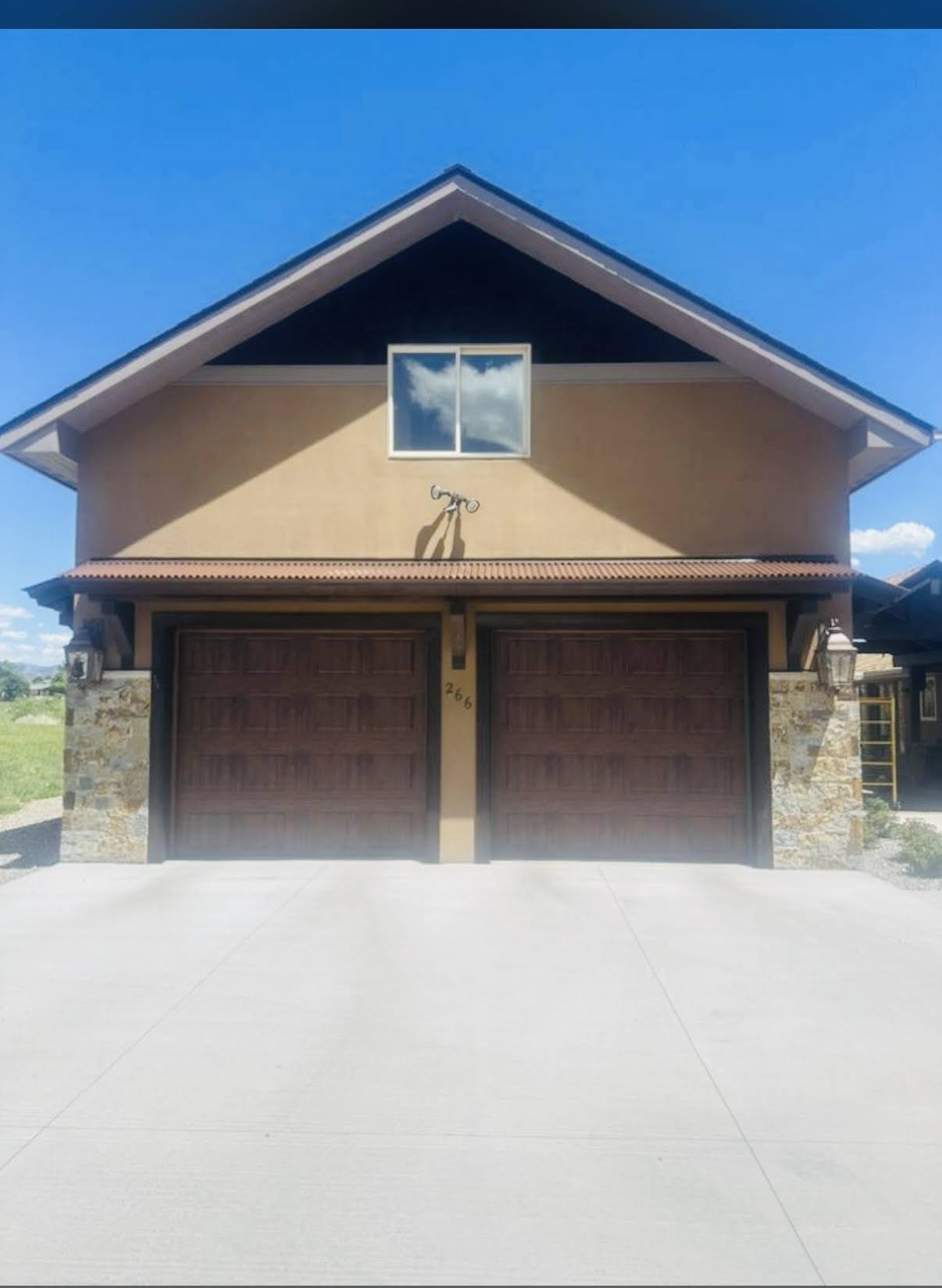 House with freshly painted exterior featuring double garage