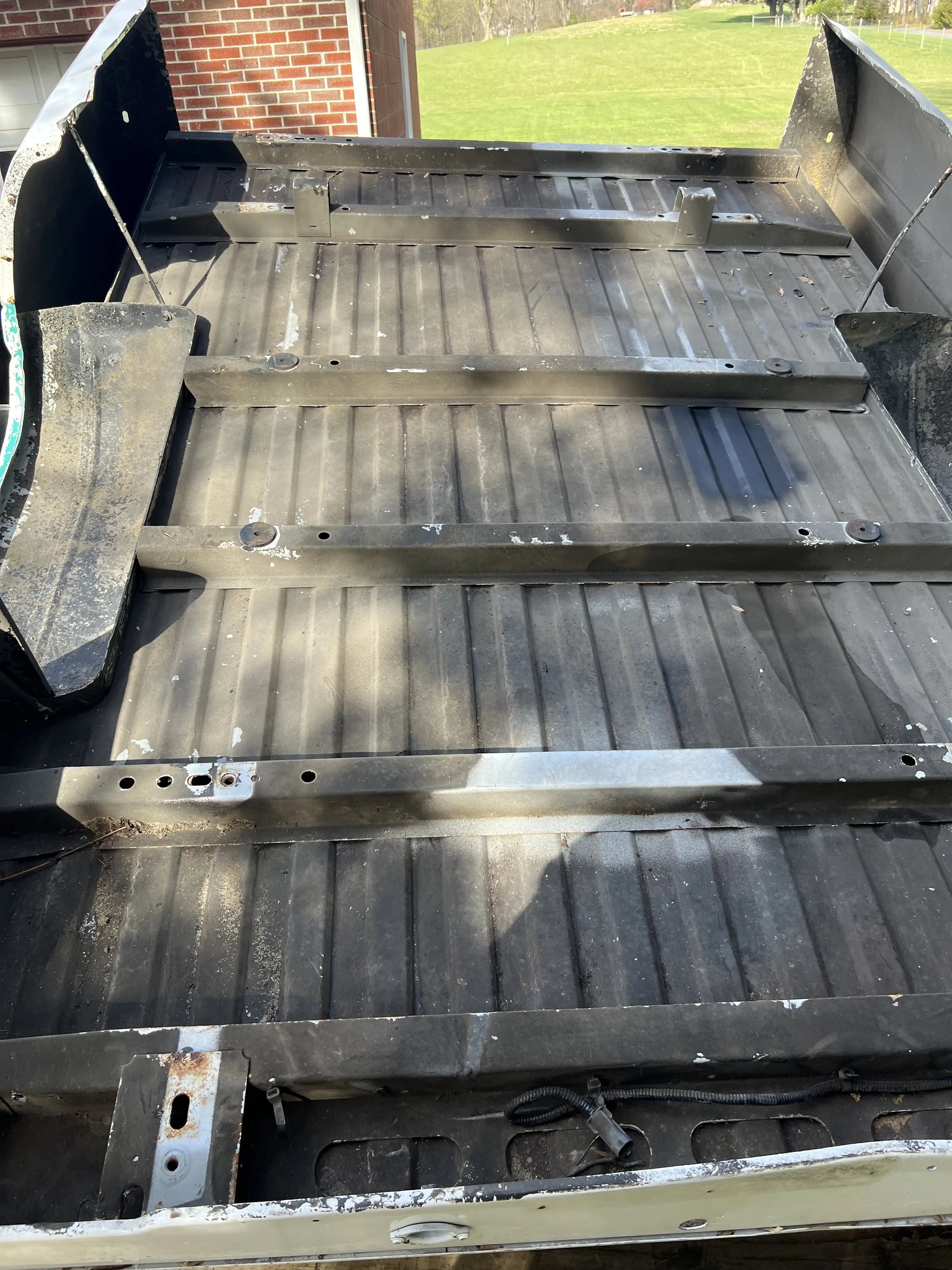Exposed metal bed frame of a pickup truck