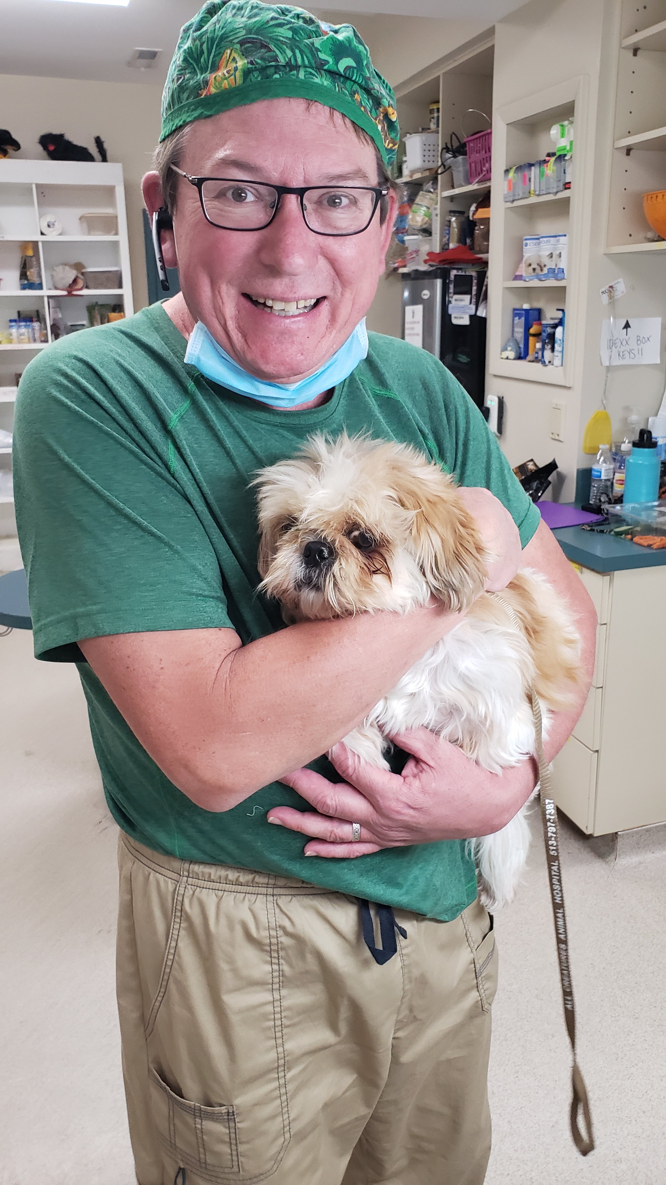 Dr. Dan holding a small dog in a veterinary clinic