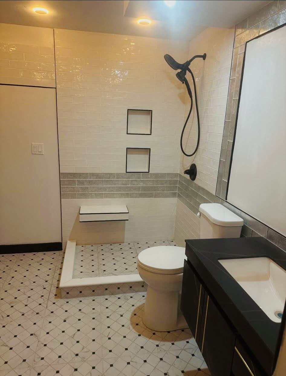 Modern bathroom with white tiles and black accents