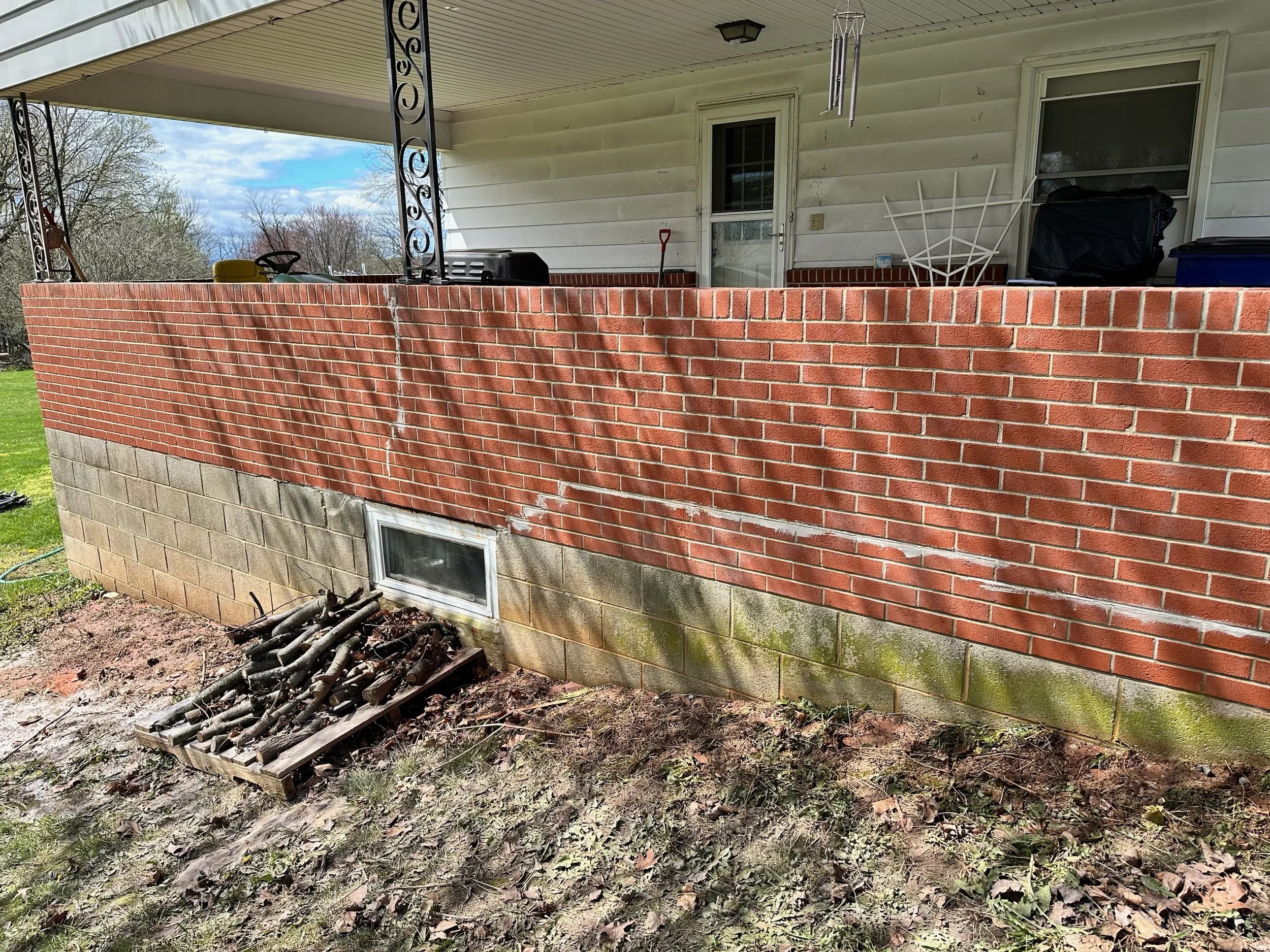A brick wall with a small window after cleaning
