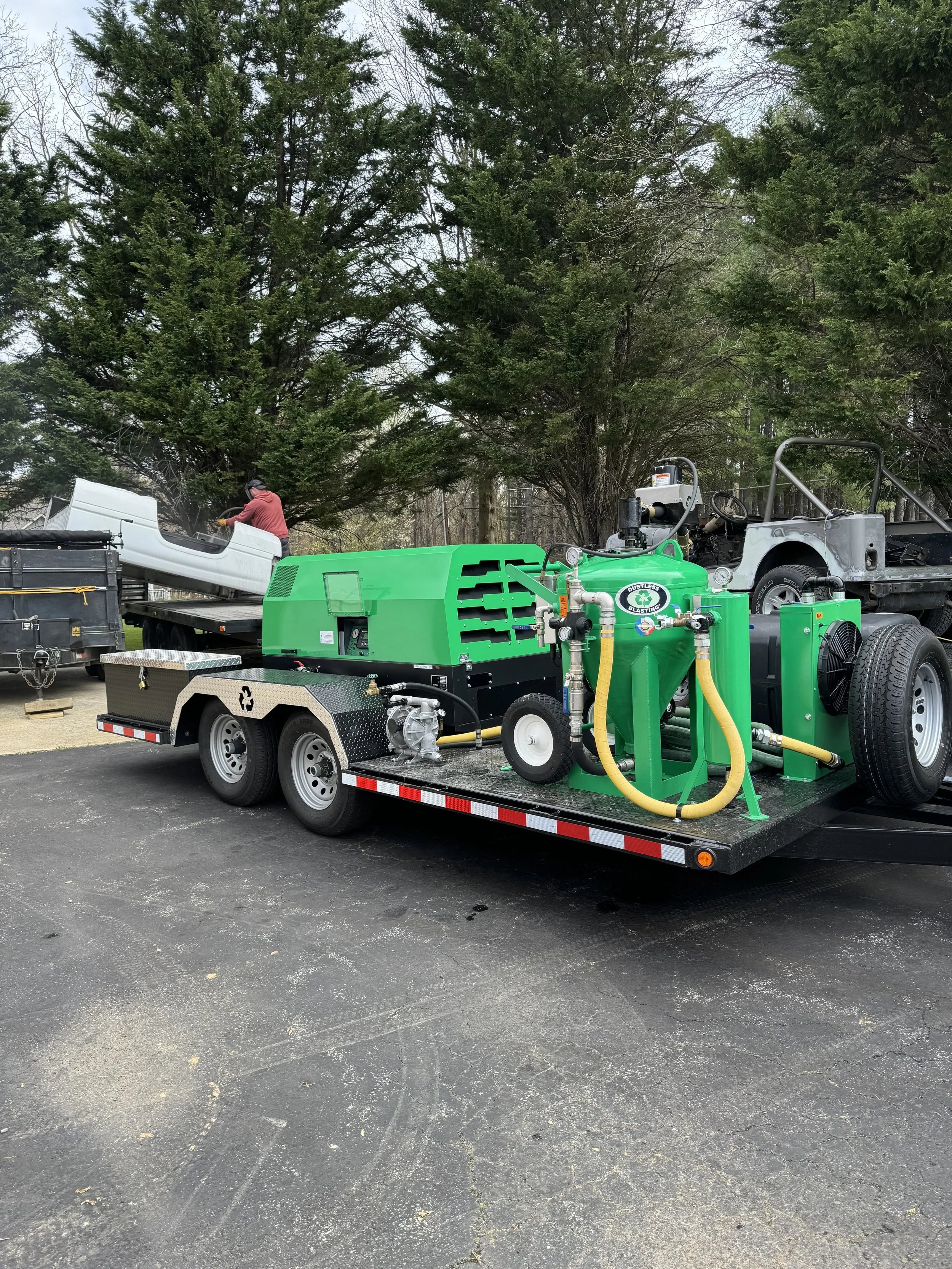 Green industrial equipment on a flatbed trailer