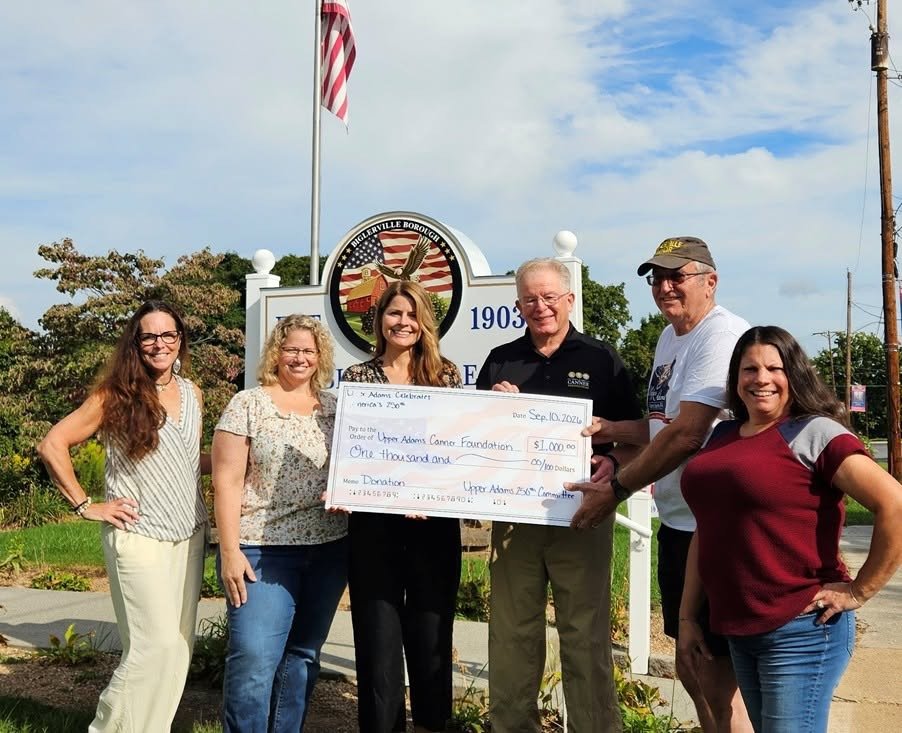 A group of people holding a check for the Upper Adams Cancer Foundation