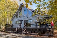 Cabin surrounded by autumn trees in the Lake Region